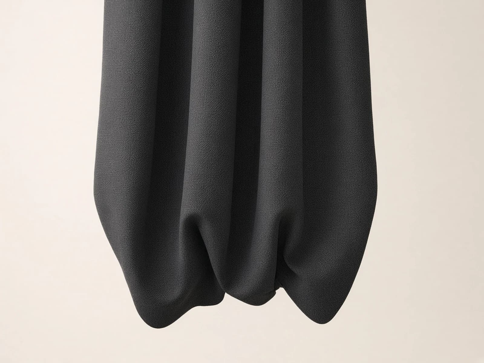 Dense charcoal acoustic drape fabric with substantial folds