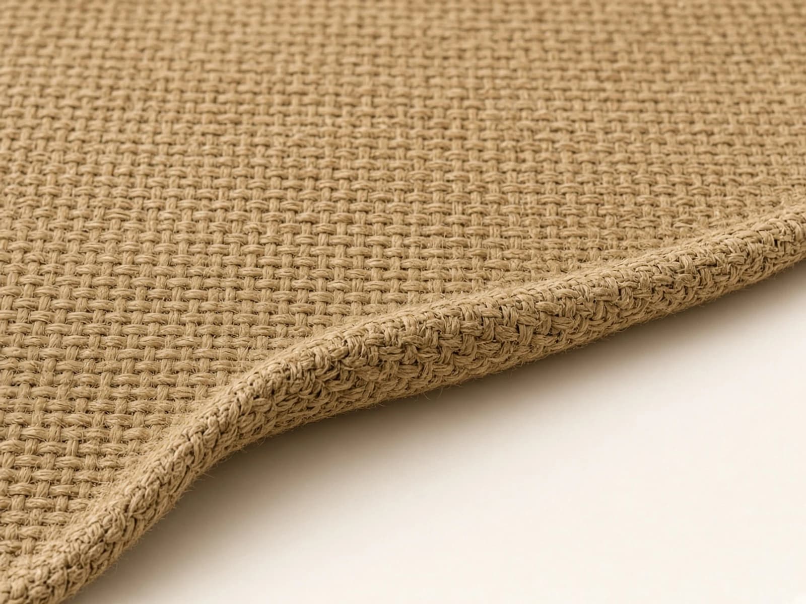 Natural tan jute rug with coarse dry woven bast fibers