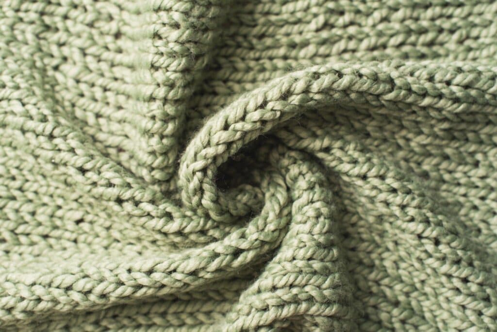 Knit fabric laid flat, showing a looped construction
