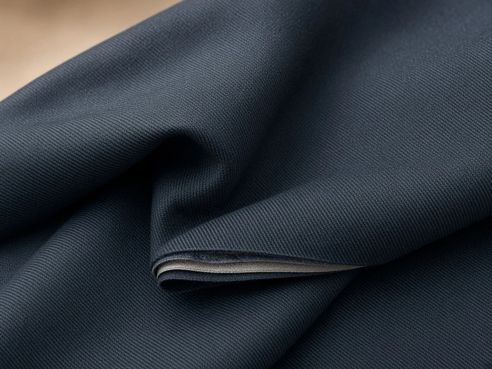 Membrane-backed covert with a compact technical twill and layered edge