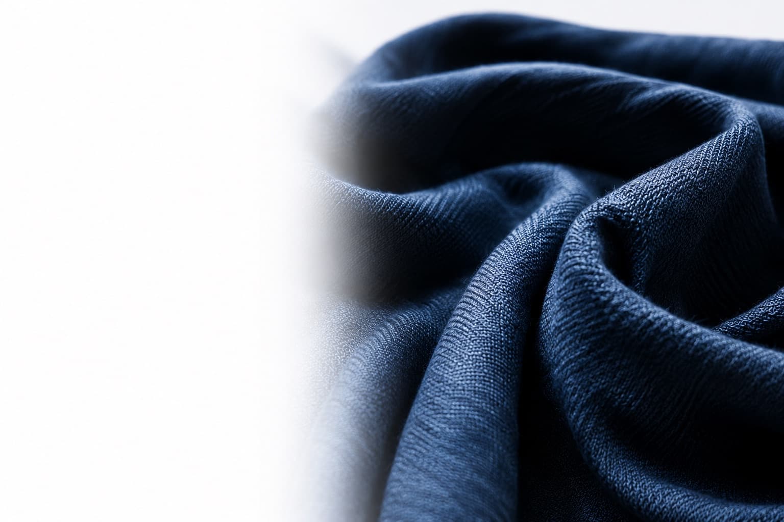Deep navy fabric folded into fluid contours
